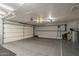 Spacious garage with epoxy flooring, ample lighting, and overhead storage racks for organized storage solutions at 1461 W Tara Dr, Gilbert, AZ 85233
