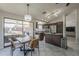 A kitchen and dining area with granite countertops, stainless steel appliances, and access to a backyard patio at 1461 W Tara Dr, Gilbert, AZ 85233
