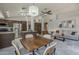 A kitchen and living area with stainless steel appliances, granite countertops, and a dining area at 1461 W Tara Dr, Gilbert, AZ 85233