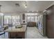 A kitchen and dining area with stainless steel appliances, granite countertops and access to the backyard at 1461 W Tara Dr, Gilbert, AZ 85233