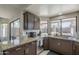 Kitchen with granite countertops, stainless steel appliances, and views of the backyard patio at 1461 W Tara Dr, Gilbert, AZ 85233