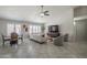 Open living space featuring tile floors, a ceiling fan, and shuttered windows at 1461 W Tara Dr, Gilbert, AZ 85233