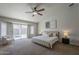 Main bedroom with natural light, ceiling fan and access to private backyard jacuzzi at 1461 W Tara Dr, Gilbert, AZ 85233