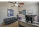 Cozy office space features a modern desk, sleeper sofa, and tasteful sports memorabilia at 1461 W Tara Dr, Gilbert, AZ 85233