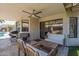 Covered patio with a ceiling fan, outdoor seating, and grilling area at 1461 W Tara Dr, Gilbert, AZ 85233