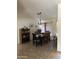 Bright dining room featuring a wood dining table set and elegant chandelier at 14617 S 35Th Pl, Phoenix, AZ 85044