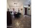 Bright dining room with a chandelier, vaulted ceiling, and beautiful tile floors at 14617 S 35Th Pl, Phoenix, AZ 85044