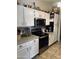 Well-maintained kitchen featuring stainless steel appliances and white cabinetry at 14617 S 35Th Pl, Phoenix, AZ 85044