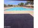 Community outdoor swimming pool with lounge chairs and sun shades at 14617 S 35Th Pl, Phoenix, AZ 85044
