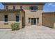 Backyard with paved patio, tan stucco exterior, and minimal landscaping at 14881 W Ashland Ave, Goodyear, AZ 85395