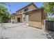 View of the backyard with paved patio, yard access door, and tan stucco exterior at 14881 W Ashland Ave, Goodyear, AZ 85395