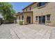 View of the backyard with paved patio and tan stucco exterior at 14881 W Ashland Ave, Goodyear, AZ 85395