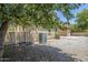 Backyard with gravel, A/C unit, patio, and mature tree providing shade at 14881 W Ashland Ave, Goodyear, AZ 85395