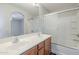 Bathroom with a double sink vanity and glass enclosed tub/shower at 14881 W Ashland Ave, Goodyear, AZ 85395