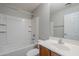 Bathroom with tub, shower, single sink vanity, mirror and white walls at 14881 W Ashland Ave, Goodyear, AZ 85395
