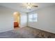 A neutral bedroom with a ceiling fan, carpeted floor and an archway to the bathroom at 14881 W Ashland Ave, Goodyear, AZ 85395