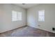 Clean, carpeted room, featuring a large window for natural light and neutral paint at 14881 W Ashland Ave, Goodyear, AZ 85395