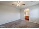 A light and airy bedroom showing neutral walls, carpeted floor and archway to the bathroom at 14881 W Ashland Ave, Goodyear, AZ 85395
