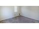 Neutral bedroom featuring carpet flooring, a large window, and neutral paint at 14881 W Ashland Ave, Goodyear, AZ 85395