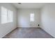 Clean, carpeted room, featuring a large window for natural light and neutral paint at 14881 W Ashland Ave, Goodyear, AZ 85395