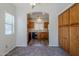 Cozy dining area with modern lighting, built-in storage, and an archway leading to the kitchen at 14881 W Ashland Ave, Goodyear, AZ 85395
