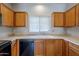 Classic kitchen design with light wood cabinets and neutral countertops at 14881 W Ashland Ave, Goodyear, AZ 85395