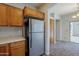 Efficient kitchen design with wooden cabinetry and stainless steel refrigerator at 14881 W Ashland Ave, Goodyear, AZ 85395