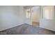 Large living room with neutral paint, showing the entryway and second floor staircase at 14881 W Ashland Ave, Goodyear, AZ 85395