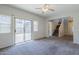Bright and airy living room featuring sliding glass doors and a staircase to the second floor at 14881 W Ashland Ave, Goodyear, AZ 85395