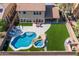 Aerial view of a backyard showcasing a pool, spa, patio, and synthetic grass at 16206 W Cocopah St, Goodyear, AZ 85338