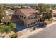 Expansive aerial view of a two-story home highlighting the roof, large driveway, and surrounding neighborhood at 16206 W Cocopah St, Goodyear, AZ 85338