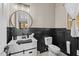 Stylish bathroom features a black and white design with modern fixtures and elegant accents at 16206 W Cocopah St, Goodyear, AZ 85338