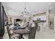 A well-decorated dining room with a round wood table is centrally located between the living room and the kitchen at 16206 W Cocopah St, Goodyear, AZ 85338
