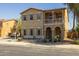 Charming home featuring a welcoming porch, desert landscaping, and an American flag on the balcony at 16206 W Cocopah St, Goodyear, AZ 85338