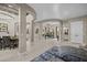 Expansive great room boasts open layout with elegant columns and seamless flow to dining area at 16206 W Cocopah St, Goodyear, AZ 85338