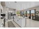 Bright kitchen featuring large island, stainless appliances, and views of outdoor space at 16206 W Cocopah St, Goodyear, AZ 85338