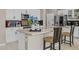 Modern kitchen with stainless steel appliances, island with seating, and sleek finishes at 16206 W Cocopah St, Goodyear, AZ 85338