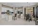 Open-concept kitchen with island seating, stainless appliances, and dining area at 16206 W Cocopah St, Goodyear, AZ 85338
