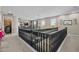 Spacious loft area offering decorative railings and a cozy carpeted floor, perfect for relaxation and versatile use at 16206 W Cocopah St, Goodyear, AZ 85338