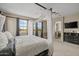 Bright primary bedroom featuring a four-poster bed, soft carpet, and a large walk-in closet at 16206 W Cocopah St, Goodyear, AZ 85338