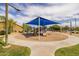 Community playground featuring slides, climbing structures, and a blue shade canopy for  at 16206 W Cocopah St, Goodyear, AZ 85338