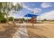 Community playground featuring slides, swings, picnic benches, and a blue shade canopy at 16206 W Cocopah St, Goodyear, AZ 85338