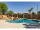Beautiful pool with rock waterfall feature and plenty of room for fun in the sun at 16206 W Cocopah St, Goodyear, AZ 85338