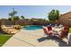 Resort-style pool with rock features and seating area, perfect for outdoor relaxation and entertainment at 16206 W Cocopah St, Goodyear, AZ 85338