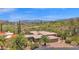 An aerial view of a desert home, golf course, and mountain views at 1702 E Staghorn Ln, Carefree, AZ 85377