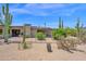 Lush backyard landscaping complements this desert home's exterior, offering serene outdoor living spaces at 1702 E Staghorn Ln, Carefree, AZ 85377