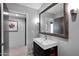 A well-lit bathroom featuring a modern vanity, stylish mirror, and neutral color palette at 1702 E Staghorn Ln, Carefree, AZ 85377