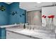 The bright bathroom features a unique marble countertop, colorful decor, and a shower at 1702 E Staghorn Ln, Carefree, AZ 85377