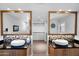 A luxurious bathroom with double vanities, elegant mirrors, and a spacious layout leading to a walk-in closet at 1702 E Staghorn Ln, Carefree, AZ 85377