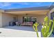 Stylish covered patio with cozy seating, blending indoor comfort with outdoor desert views at 1702 E Staghorn Ln, Carefree, AZ 85377